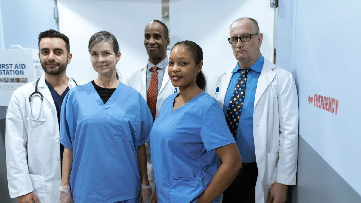A diverse group of healthcare professionals in hospital uniforms, showcasing teamwork and diversity.