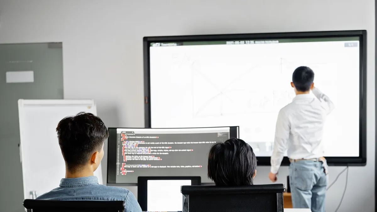 Team conducting a business presentation with technology in a modern office setting.