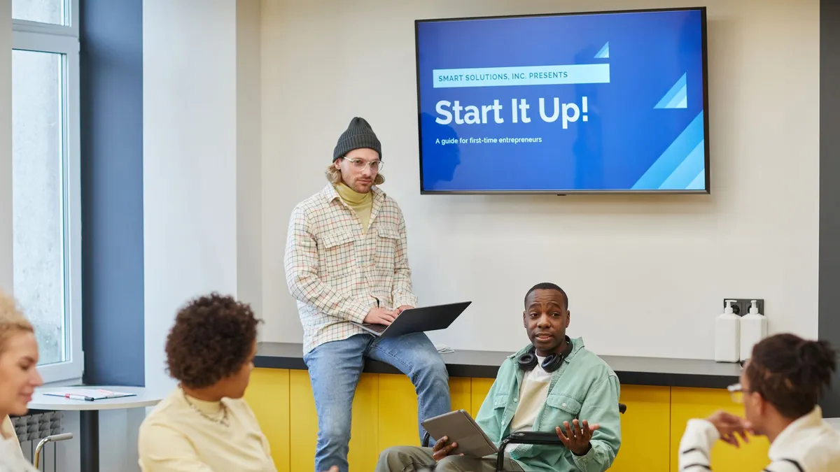 Inclusive team meeting discussing startup strategies at a modern office setting.