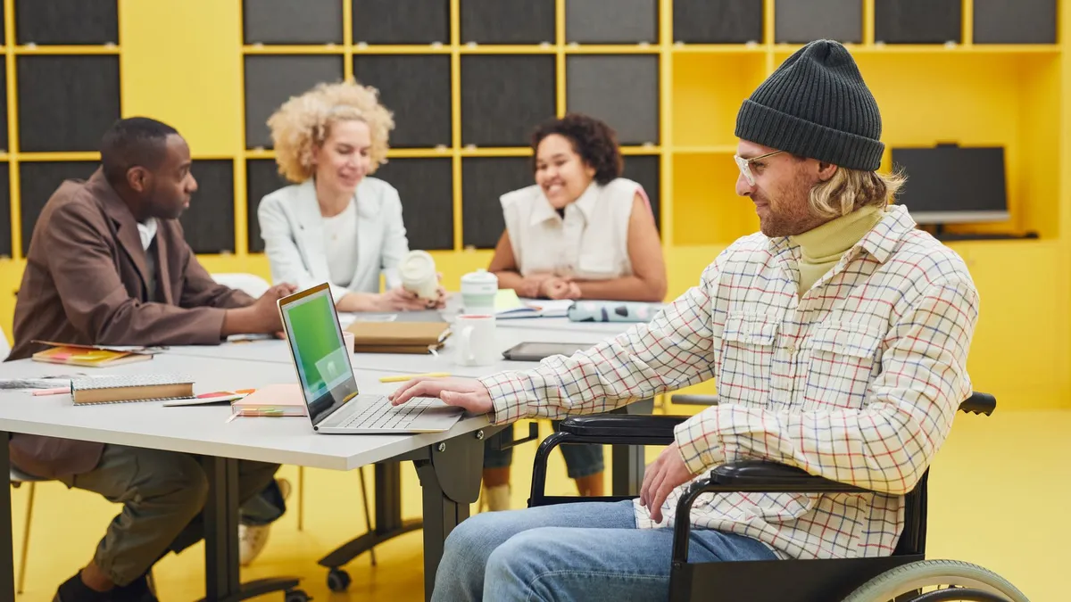 A diverse team of business professionals working together in a modern office, promoting inclusivity and teamwork.