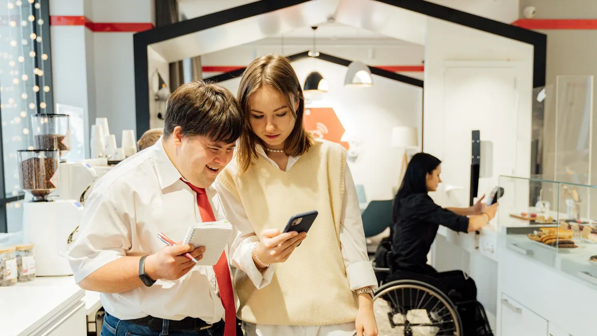 A diverse group in a coffee shop shows inclusivity and accessibility with attentive customer service.